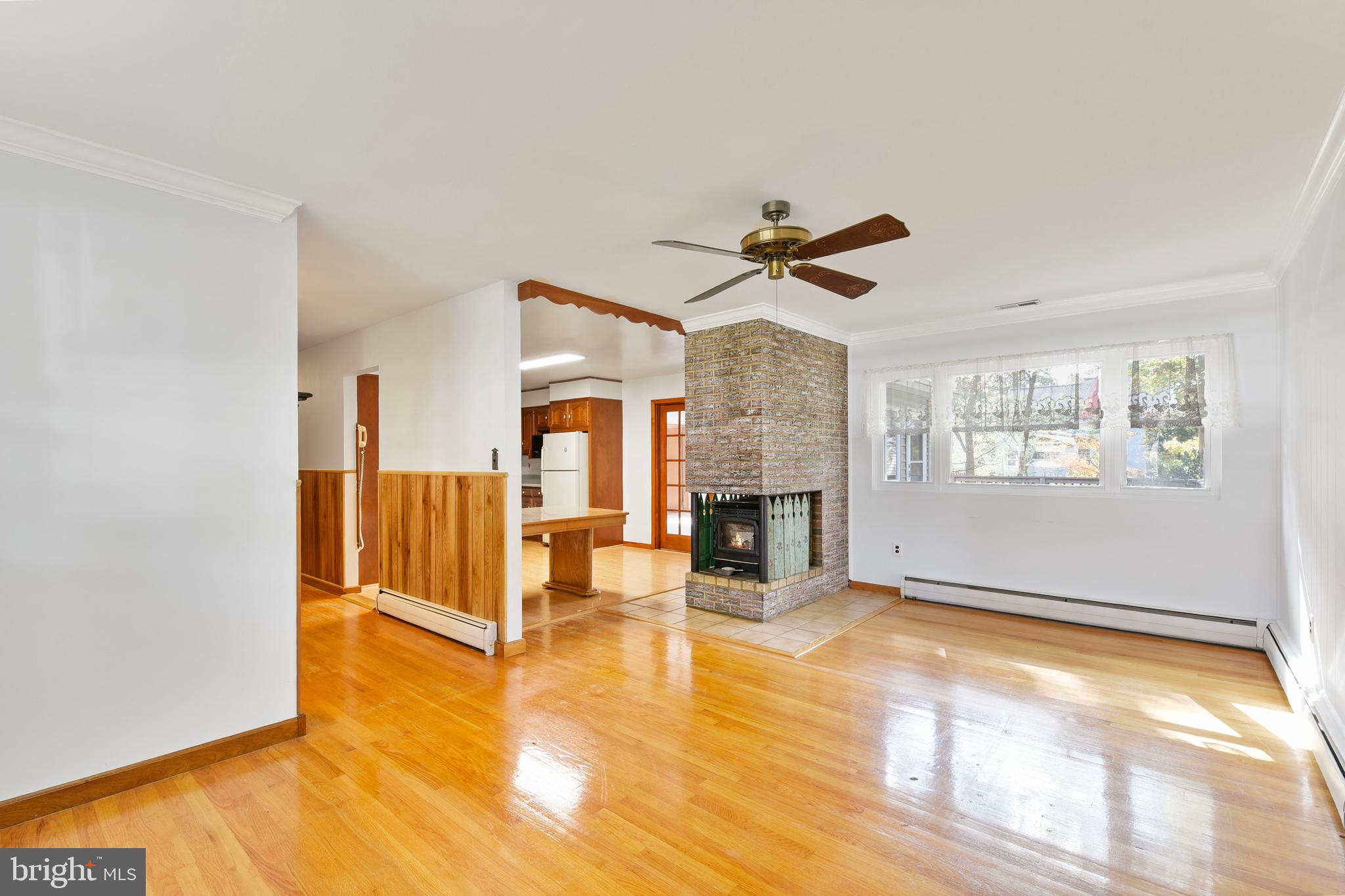 455 Community Road Severna Park, MD 21146 - Photo 14 of 51 a view of an empty room with a fireplace and a window