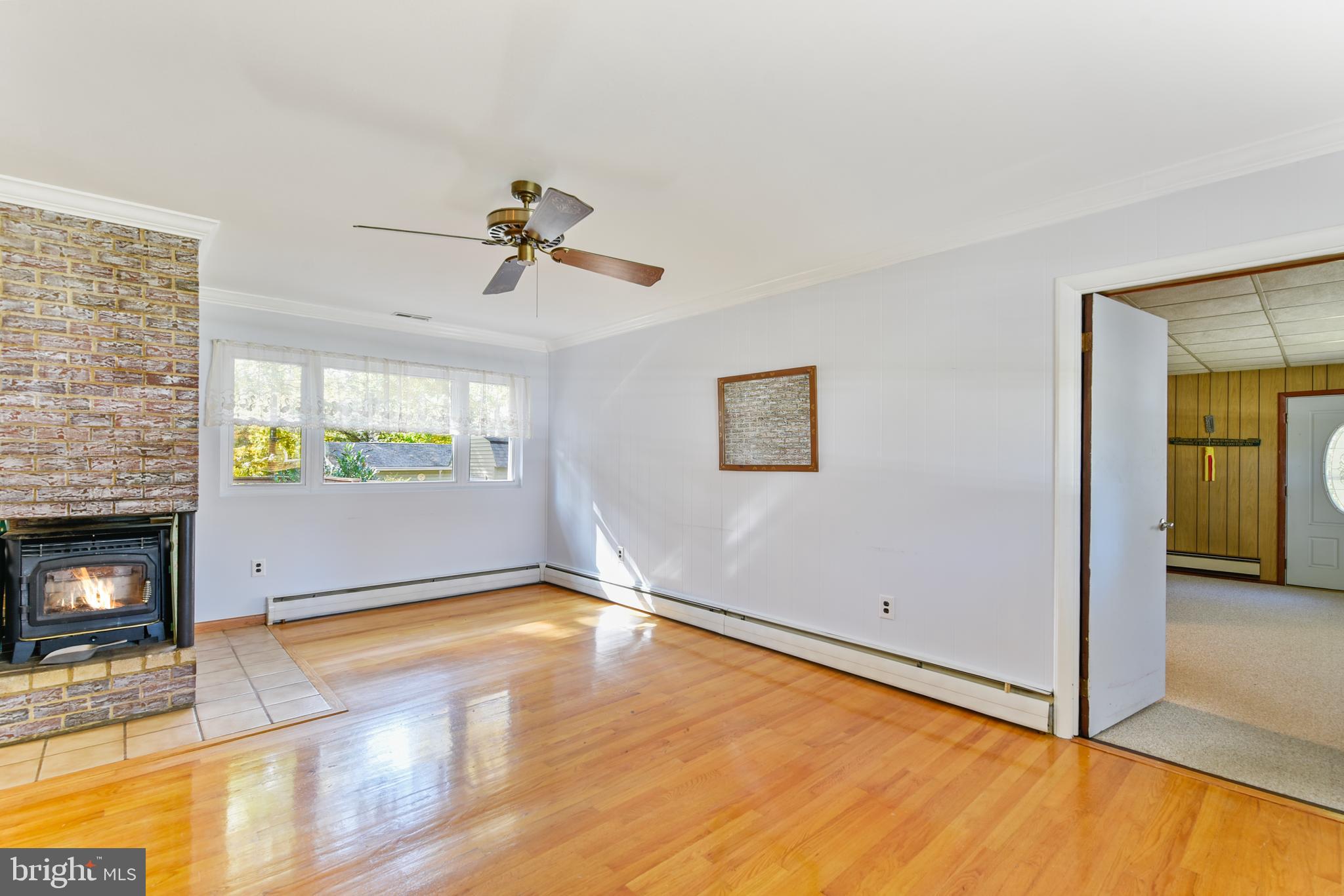 455 Community Road Severna Park, MD 21146 - Photo 15 of 51 a view of empty room with fireplace and wooden floor
