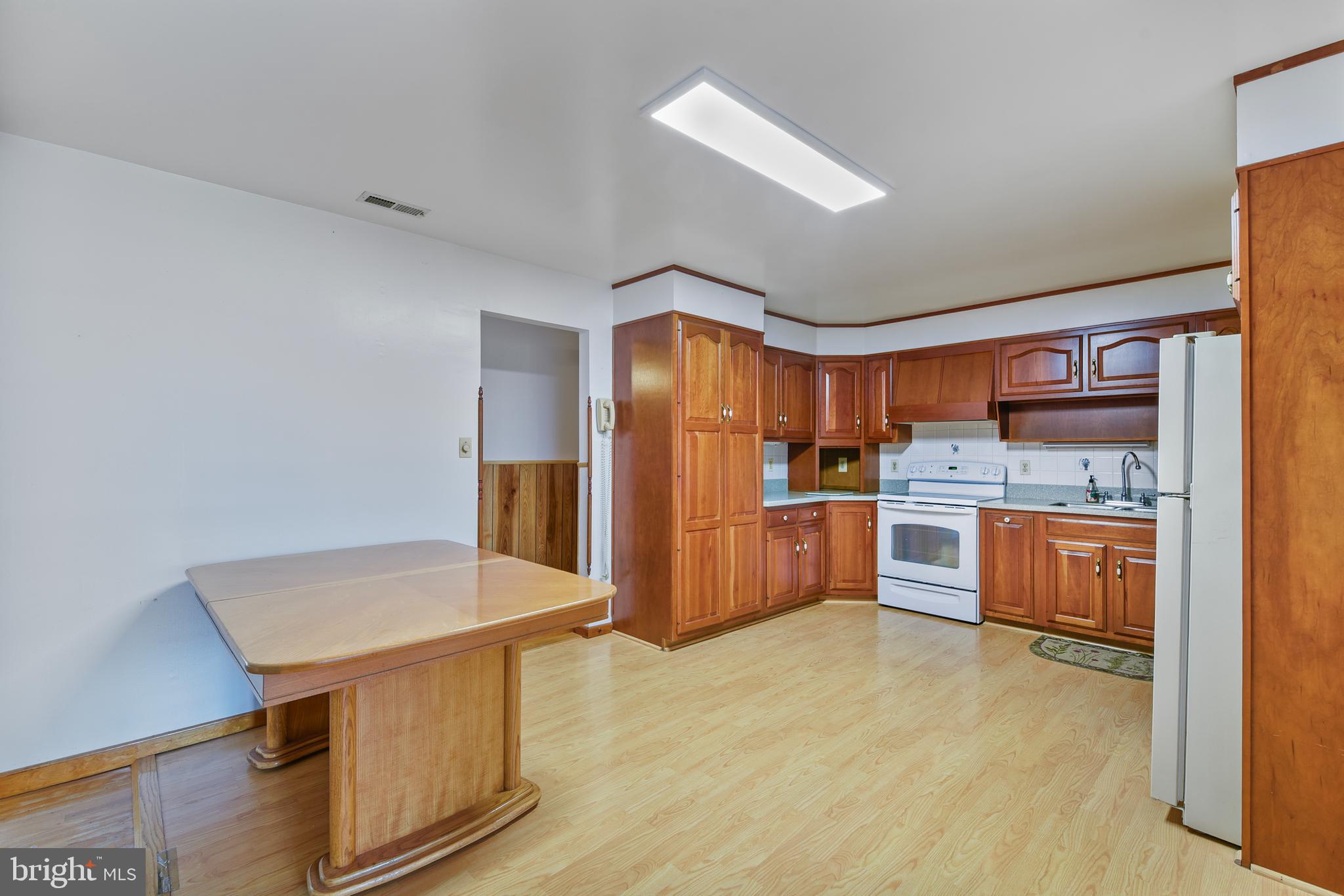 455 Community Road Severna Park, MD 21146 - Photo 17 of 51 a kitchen with stainless steel appliances a refrigerator and wooden cabinets