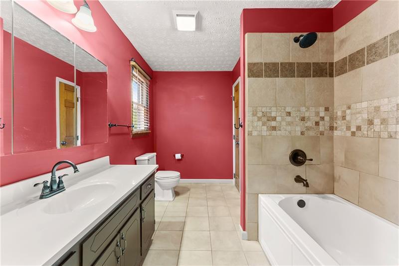 735 Calhoun Road Dahlonega, GA 30533 - Photo 16 of 53 a bathroom with a bathtub shower sink vanity and toilet