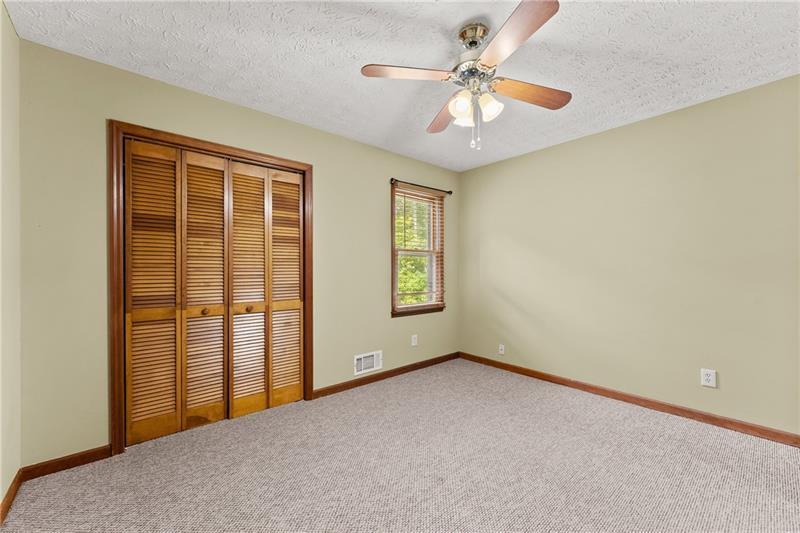735 Calhoun Road Dahlonega, GA 30533 - Photo 19 of 53 an empty room with chandelier fan