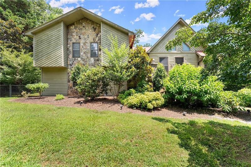 735 Calhoun Road Dahlonega, GA 30533 - Photo 2 of 53 a front view of a house with a yard