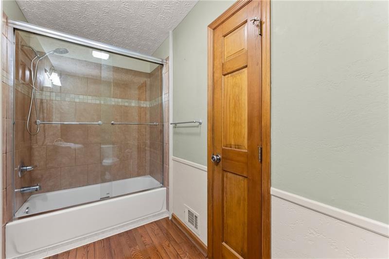 735 Calhoun Road Dahlonega, GA 30533 - Photo 22 of 53 a bathroom with a glass shower door