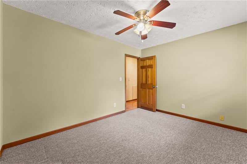 735 Calhoun Road Dahlonega, GA 30533 - Photo 24 of 53 an empty room with a chandelier fan and windows