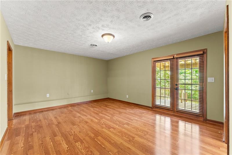 735 Calhoun Road Dahlonega, GA 30533 - Photo 26 of 53 an empty room with wooden floor and windows