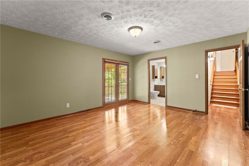 735 Calhoun Road Dahlonega, GA 30533 - Photo 27 of 53 an empty room with wooden floor and windows