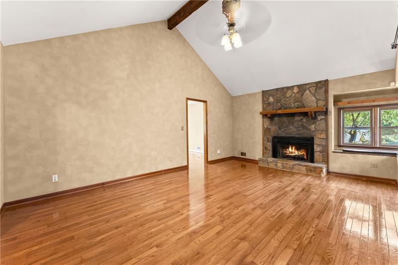 735 Calhoun Road Dahlonega, GA 30533 - Photo 4 of 53 a view of empty room with wooden floor and fireplace