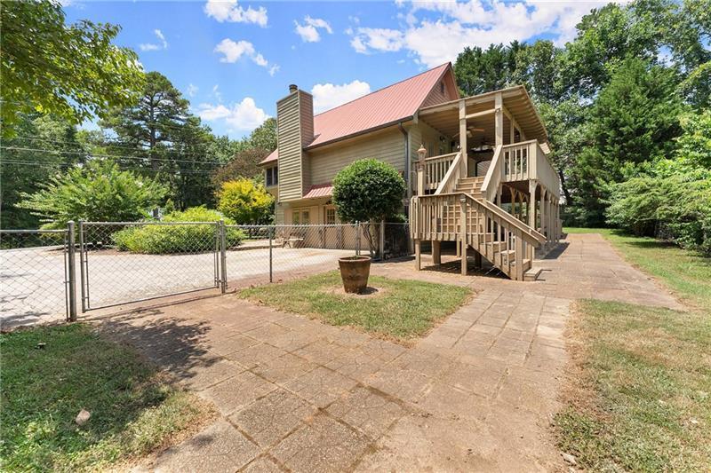 735 Calhoun Road Dahlonega, GA 30533 - Photo 42 of 53 a view of a house with backyard and trees