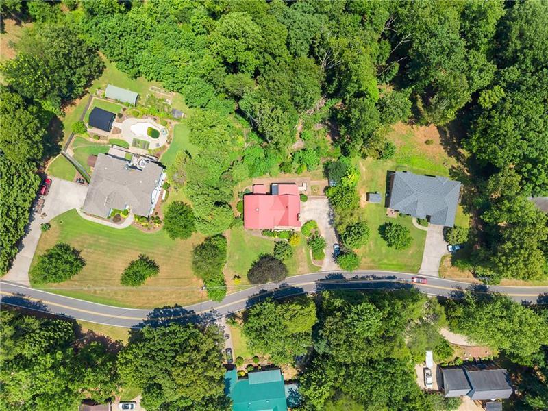 735 Calhoun Road Dahlonega, GA 30533 - Photo 47 of 53 an aerial view of a house with a yard and garden