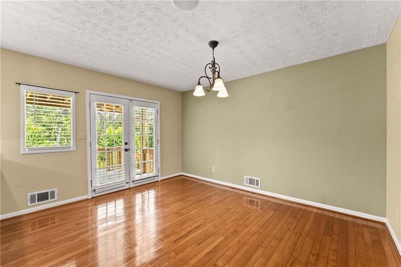 735 Calhoun Road Dahlonega, GA 30533 - Photo 7 of 53 a view of empty room with wooden floor and fan