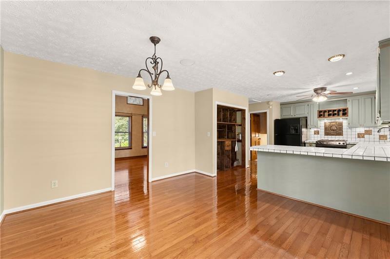 735 Calhoun Road Dahlonega, GA 30533 - Photo 8 of 53 a view of a kitchen with wooden floor and a window