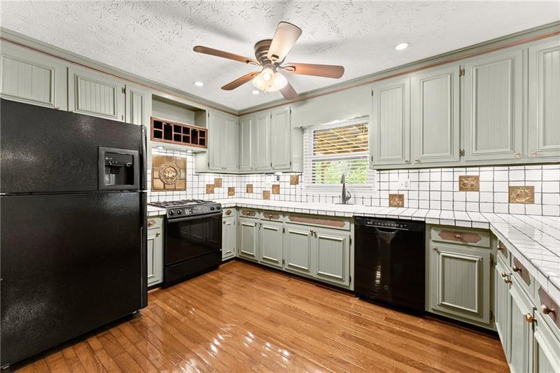 735 Calhoun Road Dahlonega, GA 30533 - Photo 10 of 53 a kitchen with a sink stove and refrigerator