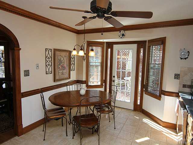 2504 Scouting Trail Raleigh, NC 27615 - Photo 5 of 18 a dining room with wooden floor a chandelier a wooden table and chairs