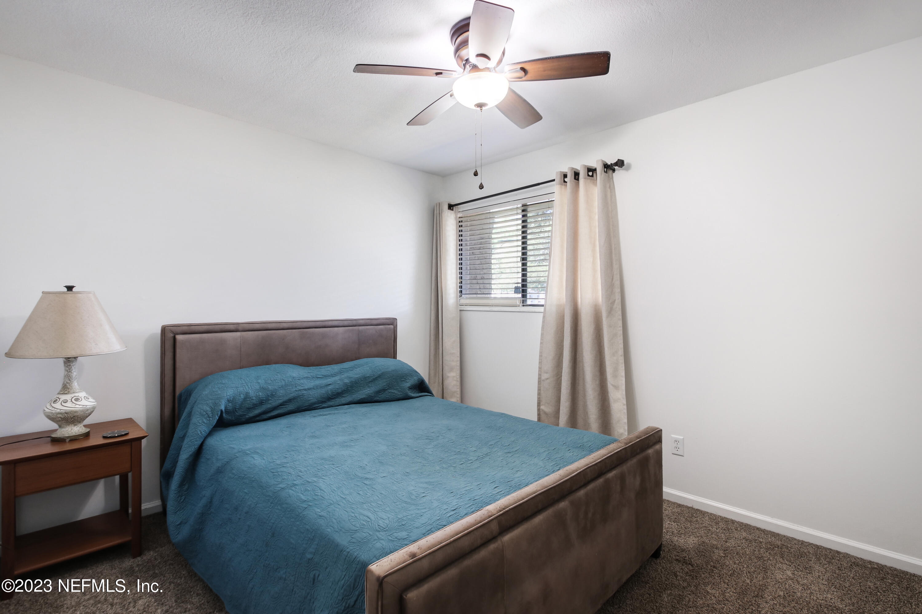 3801 Crown Point Road, Unit 3012 Jacksonville, FL 32257 - Photo 21 of 30 a bedroom with a bed and a chandelier