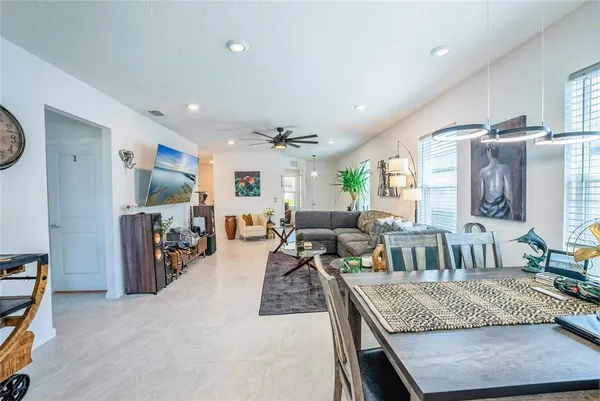 a living room with furniture a flat screen tv and a large window