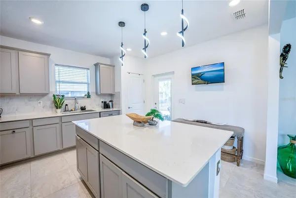 a kitchen with kitchen island a sink a counter space and appliances