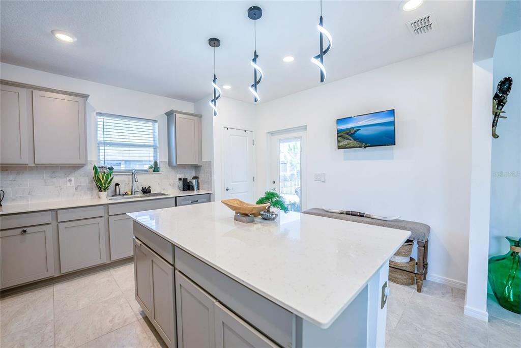 8413 Southwest 54th Street Ocala, FL 34481 - Photo 20 of 57 a kitchen with kitchen island a sink a counter space and appliances