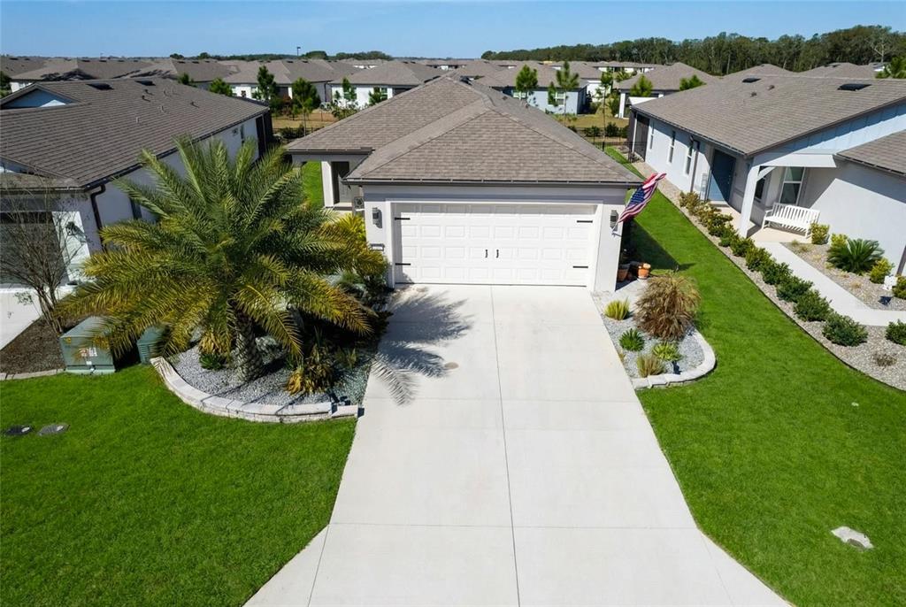 8413 Southwest 54th Street Ocala, FL 34481 - Photo 2 of 57 a aerial view of a house with a yard and potted plants