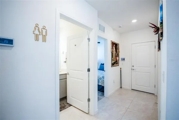a view of a hallway with closet and bathroom