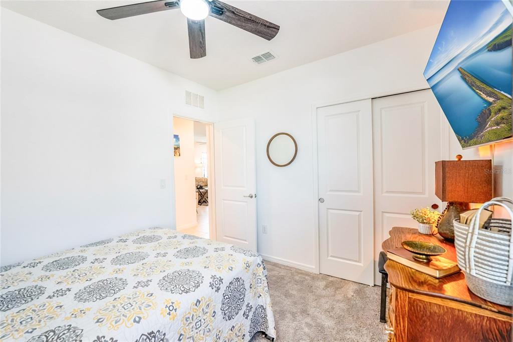 8413 Southwest 54th Street Ocala, FL 34481 - Photo 25 of 57 a bedroom with a bed and a lamp on the dresser