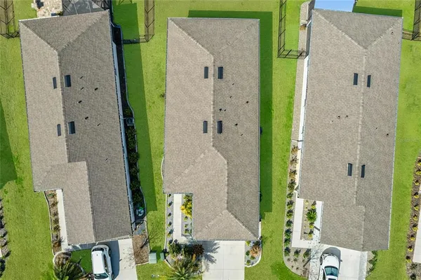 an aerial view of a house with outdoor space and a swimming pool