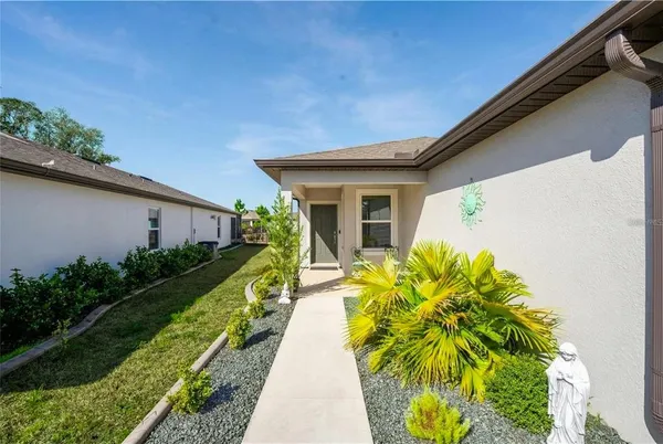 a view of house with backyard and garden