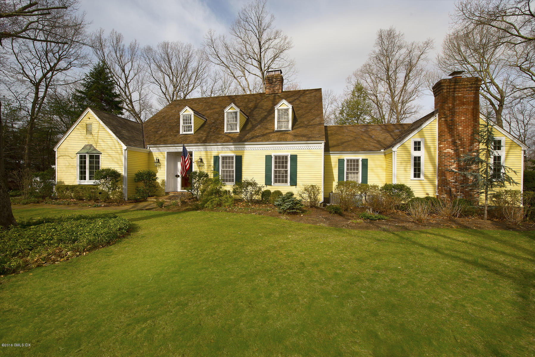 70 North Old Stone Bridge Road Cos Cob, CT 06807 - Photo 2 of 29 a front view of a house with a garden and tree