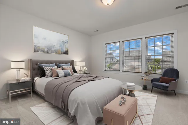 a bedroom with a bed and glass window