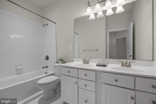 a bathroom with a double vanity sink mirror and toilet
