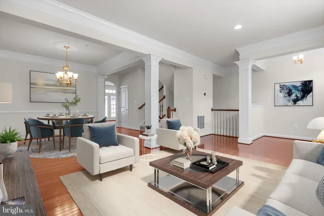 a living room with furniture and a chandelier