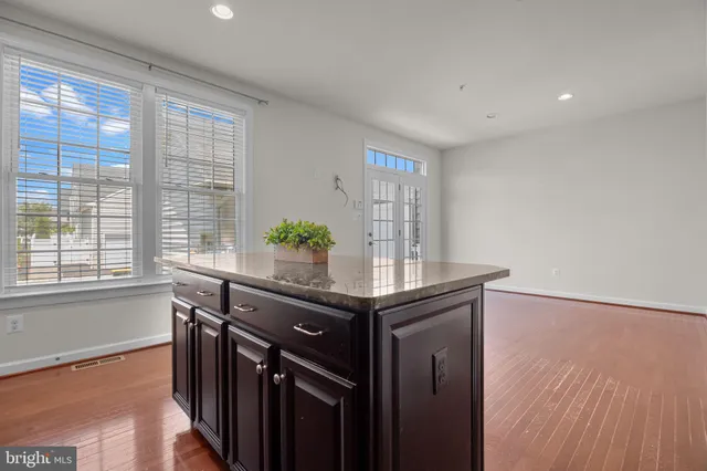 a view of a room that has a table and chairs in it
