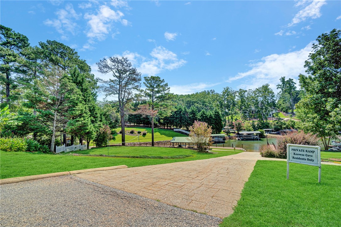 114 Summersweet Lane Seneca, SC 29672 - Photo 19 of 25 A paved path leads down to the calm, tree-lined waters of a private cove.