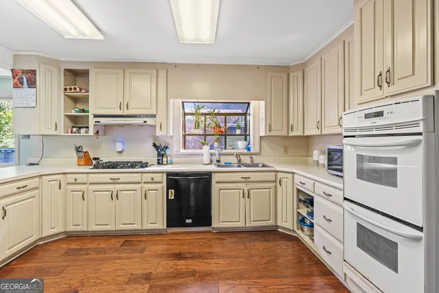 a kitchen with stainless steel appliances granite countertop a refrigerator and cabinets