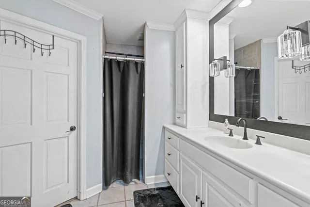 a bathroom with a granite countertop toilet sink and mirror