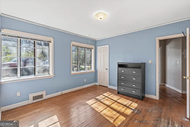 a bathroom with a granite countertop toilet sink and mirror