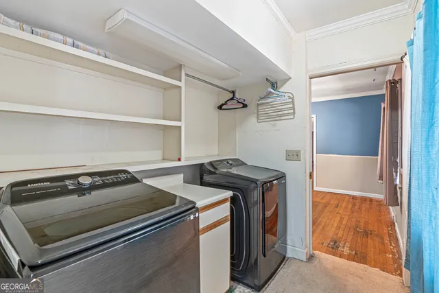 a view of a backyard with table and chairs under an umbrella