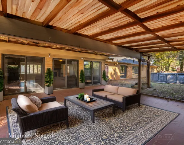 a view of a house with a yard and sitting area