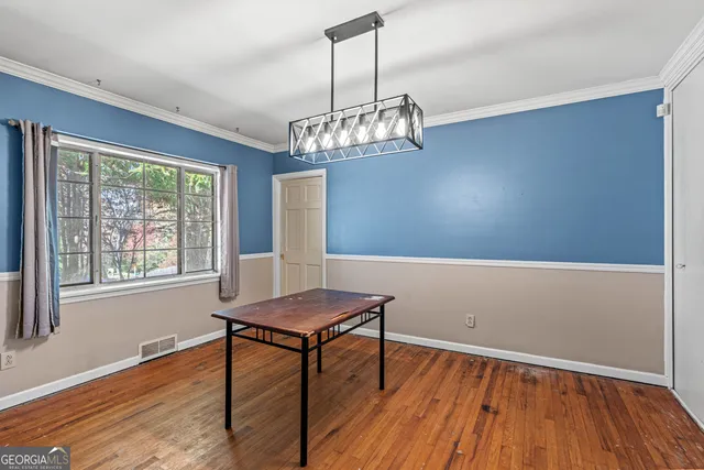 a view of a livingroom with furniture window and wooden floor