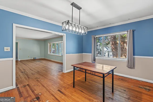 a view of a dining room with furniture and wooden floor
