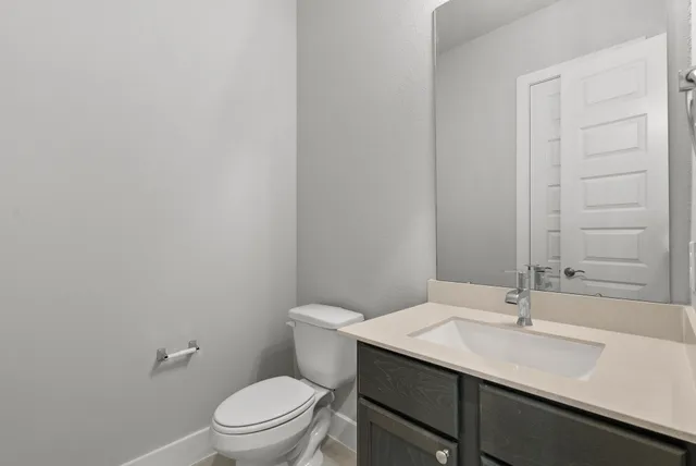 a bathroom with a sink a toilet and mirror