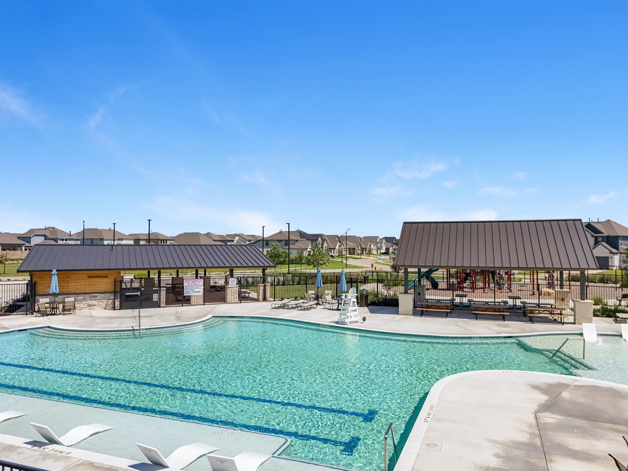 413 Hampton Edge Lane Waller, TX 77484 - Photo 5 of 8 a view of a swimming pool with a garden and seating area