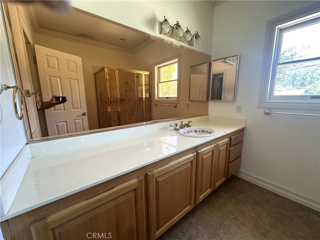 26050 Jan Valerie Road Murrieta, CA 92562 - Photo 25 of 47 a bathroom with a sink a vanity and a mirror