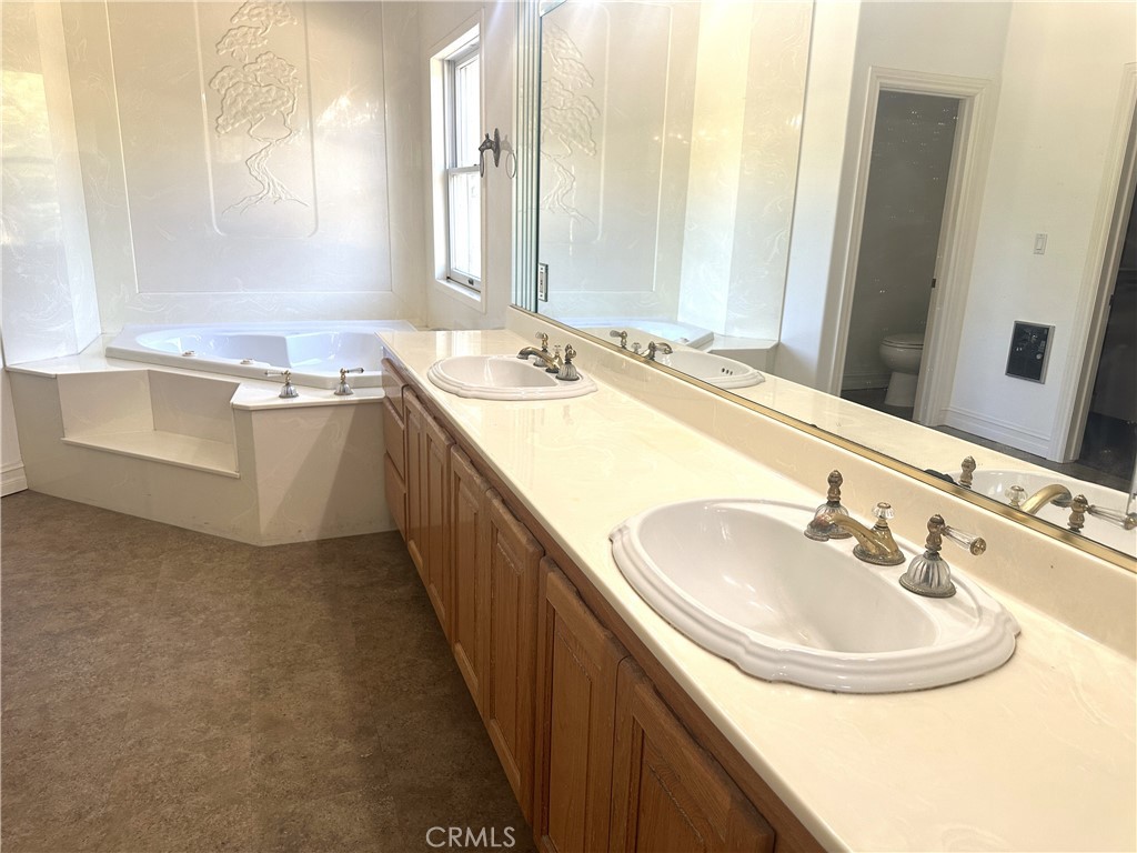 26050 Jan Valerie Road Murrieta, CA 92562 - Photo 31 of 47 a bathroom with a sink and a mirror