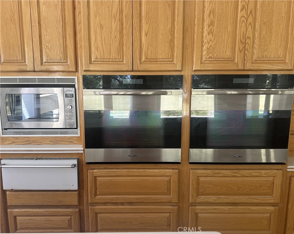 26050 Jan Valerie Road Murrieta, CA 92562 - Photo 7 of 47 a kitchen with granite countertop stainless steel appliances and cabinets