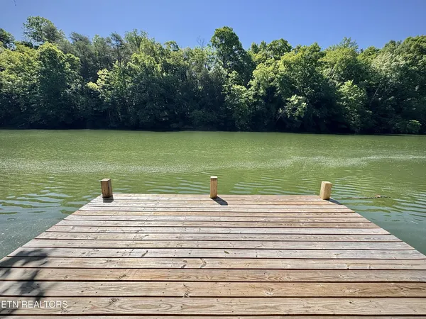 a swimming pool view with a lake view in back