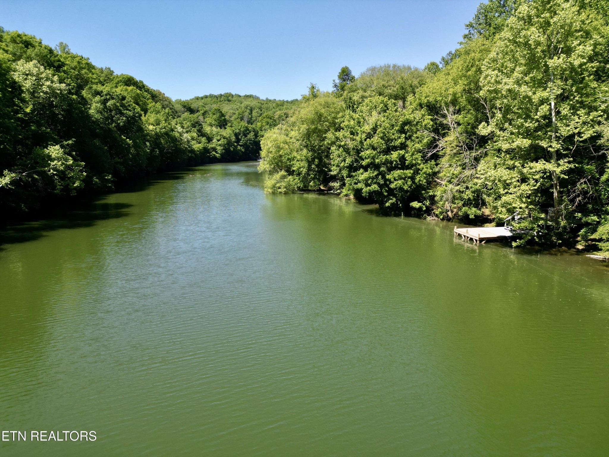 983 River Hill Road Sparta, TN 38583 - Photo 11 of 47 a view of a lake with a house in the background