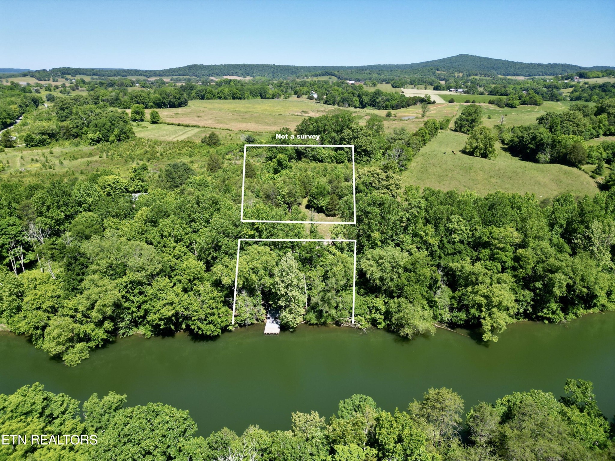 983 River Hill Road Sparta, TN 38583 - Photo 6 of 47 a view of a lake with a mountain in the background