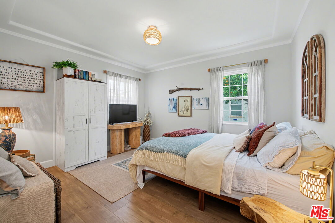 1135 West 81st Place Los Angeles, CA 90044 - Photo 13 of 23 a bedroom with a bed and a flat screen tv