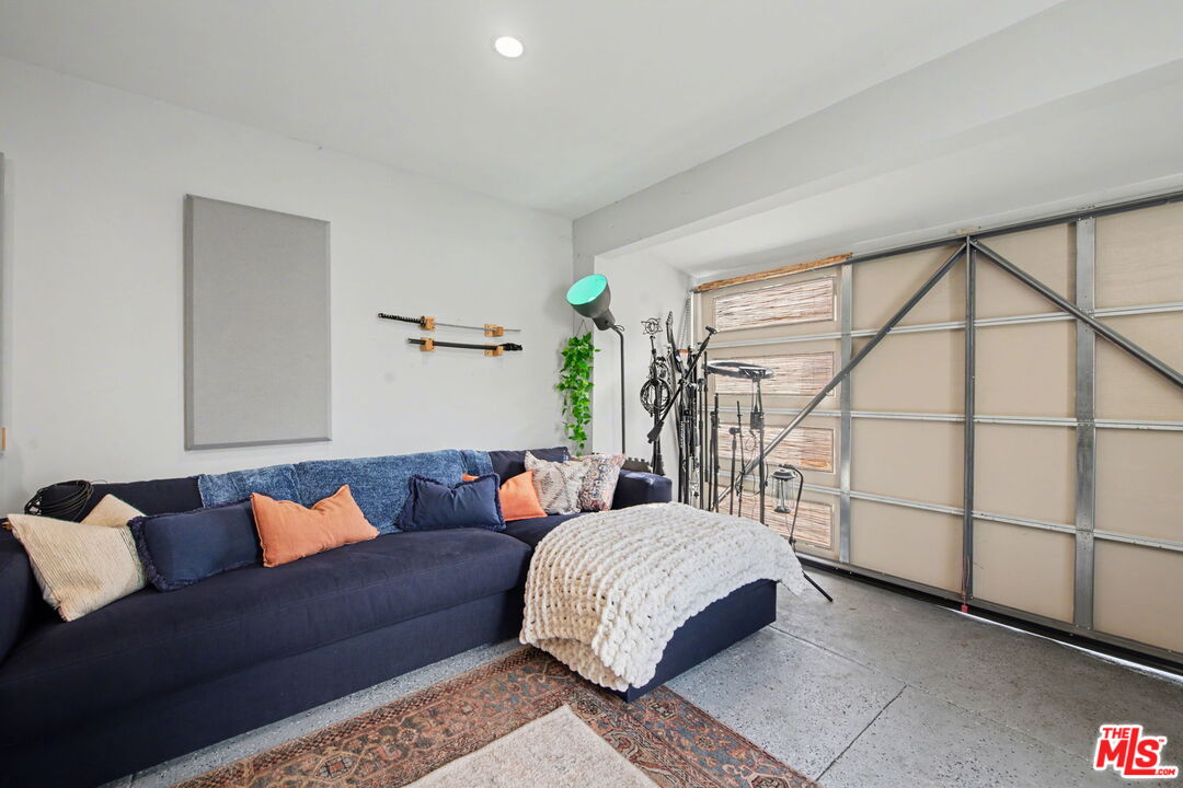 1135 West 81st Place Los Angeles, CA 90044 - Photo 21 of 23 a living room with furniture a rug and a window