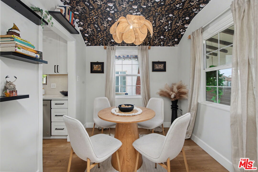 1135 West 81st Place Los Angeles, CA 90044 - Photo 6 of 23 a view of a dining room with furniture and wooden floor